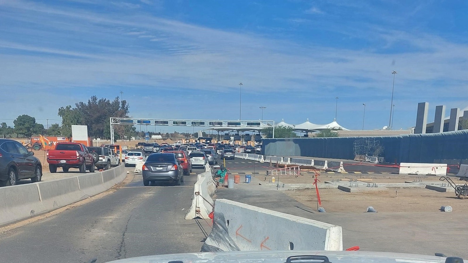 Vehicles queue at the international border crossing in Mexicali, Mexico