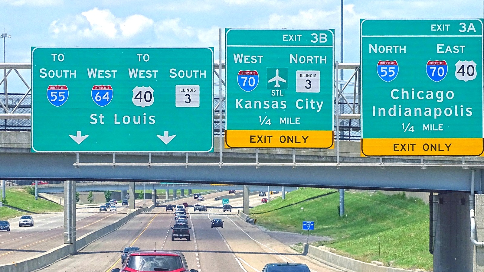 Westbound I-64 corridor signs near East St. Louis showing Interstate 64, 55, and 70 route shields for the St. Louis approach