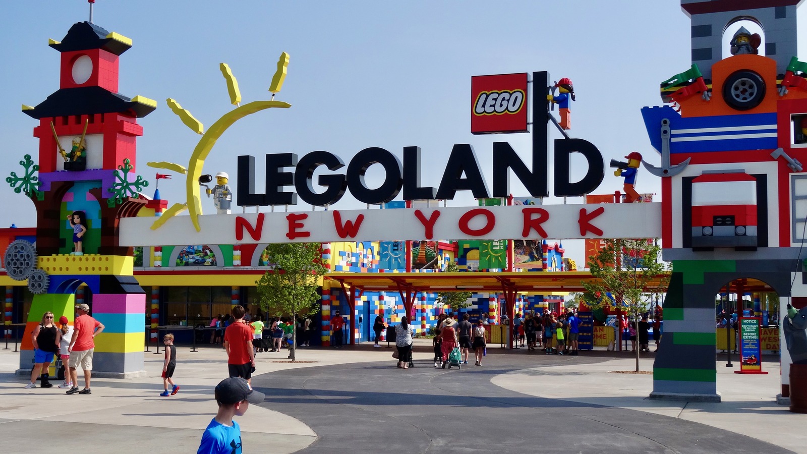 Aerial overview of LEGOLAND New York Resort buildings, rides, and parking areas in Goshen