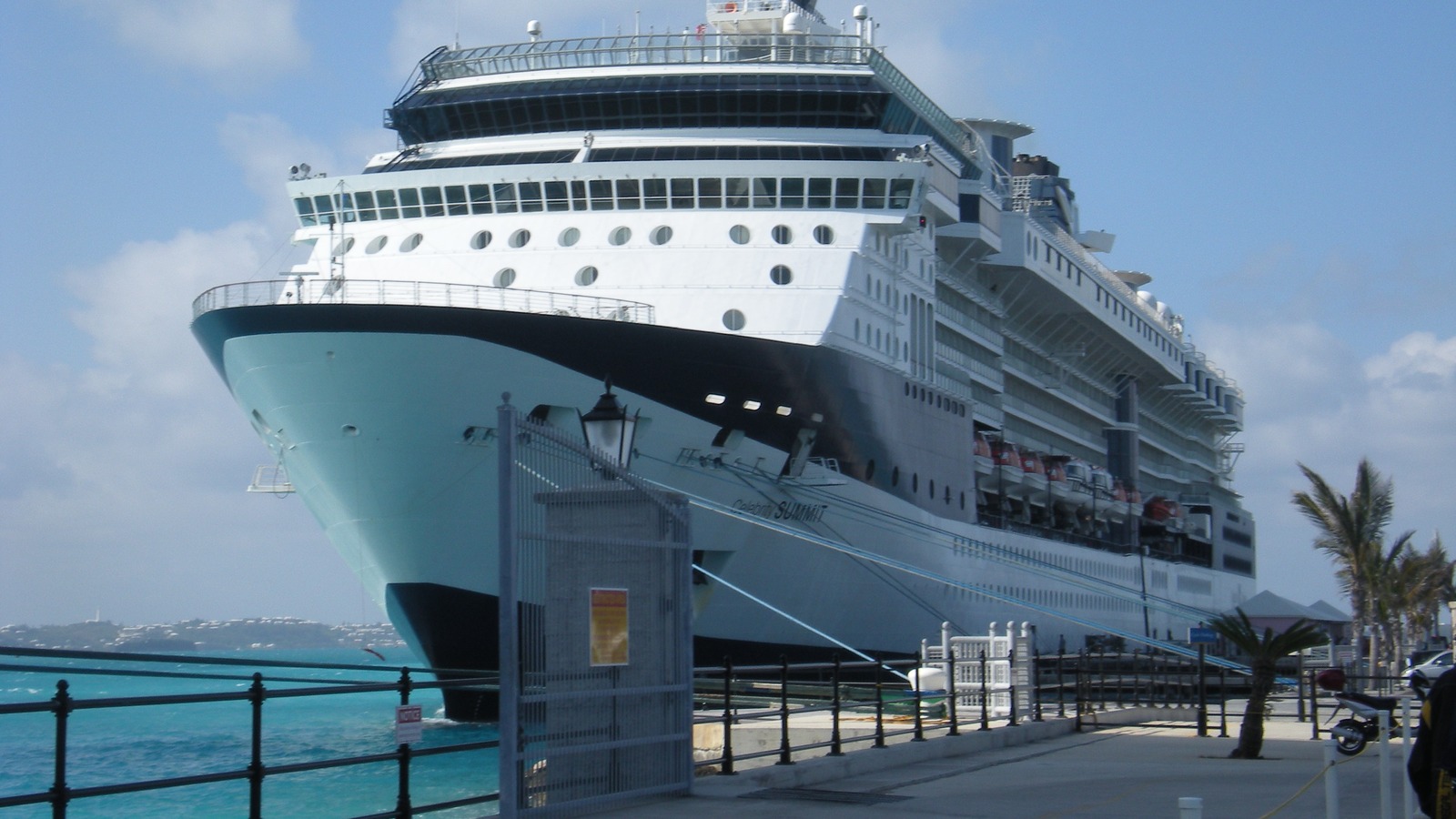 Celebrity Summit cruise ship bow and superstructure docked at pier under blue sky