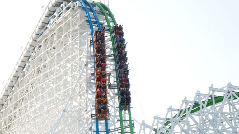 Twisted Colossus hybrid roller coaster trains racing at Six Flags Magic Mountain