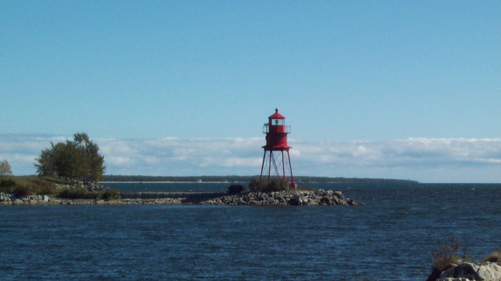 Alpena's red harbor lighthouse at the mouth of Thunder Bay River