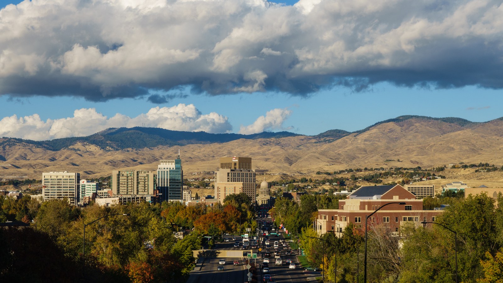 Downtown Boise, Idaho with fall foliage in the foreground and the Boise Front foothills behind