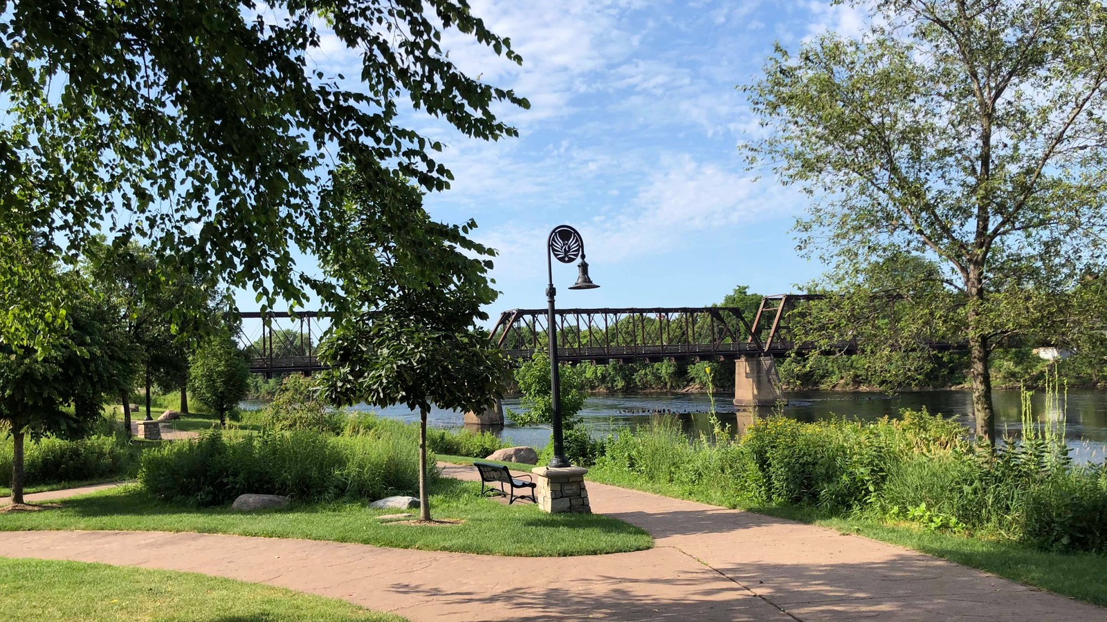 Pedestrian bridge and riverfront at Phoenix Park in Eau Claire
