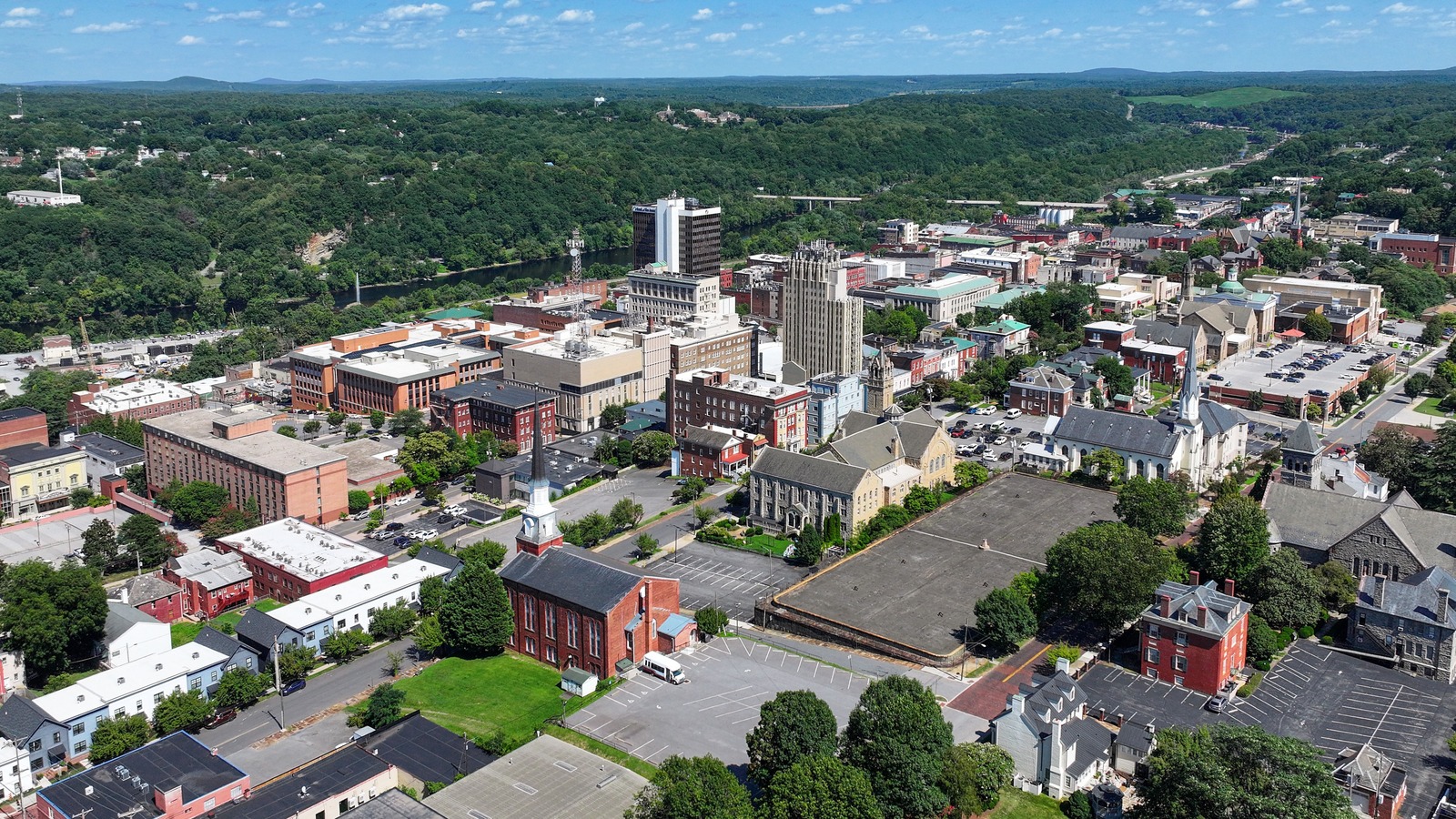 Aerial view of downtown Lynchburg, Virginia, beside the James River and wooded hills