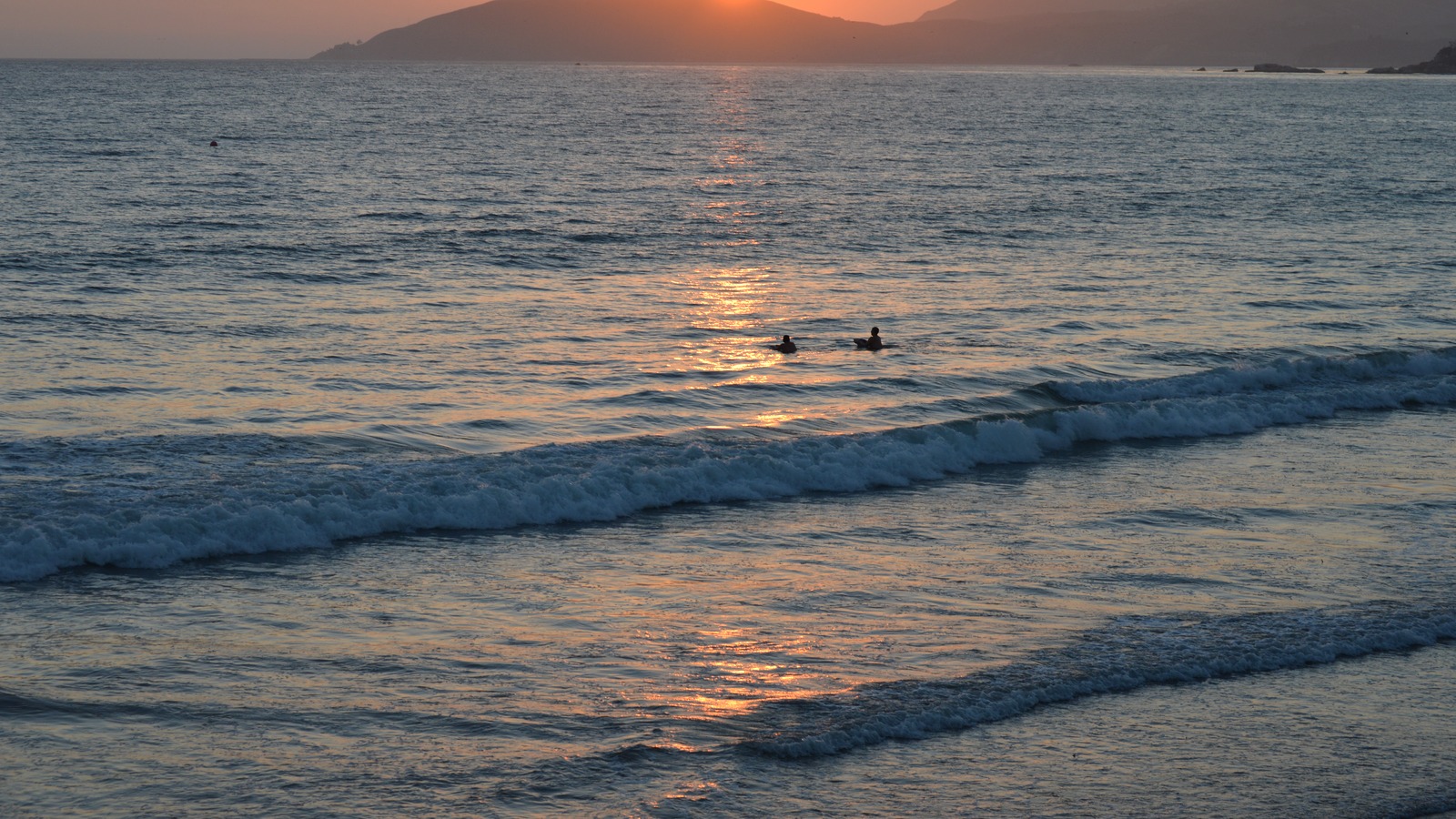 Sunset over the surf at Pismo Beach