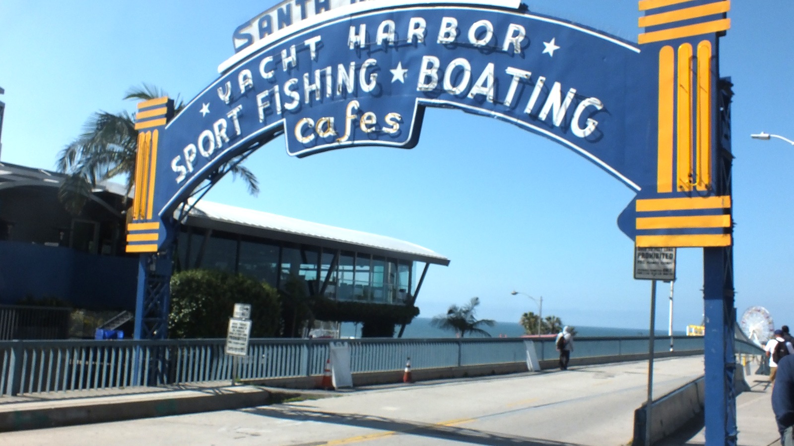 Historic Santa Monica Pier entrance sign above the pier ramp