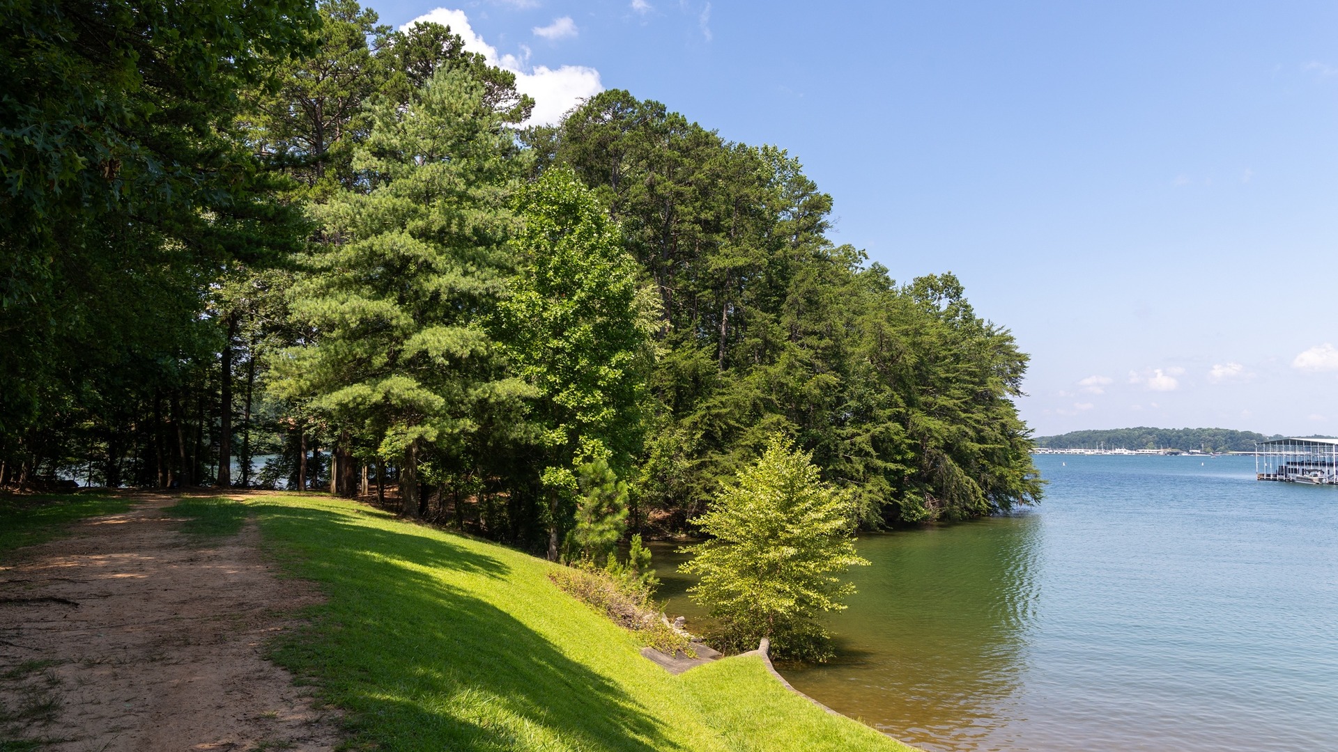 Open water and a wooded shoreline on Lake Lanier seen from Burton Mill Park in Georgia