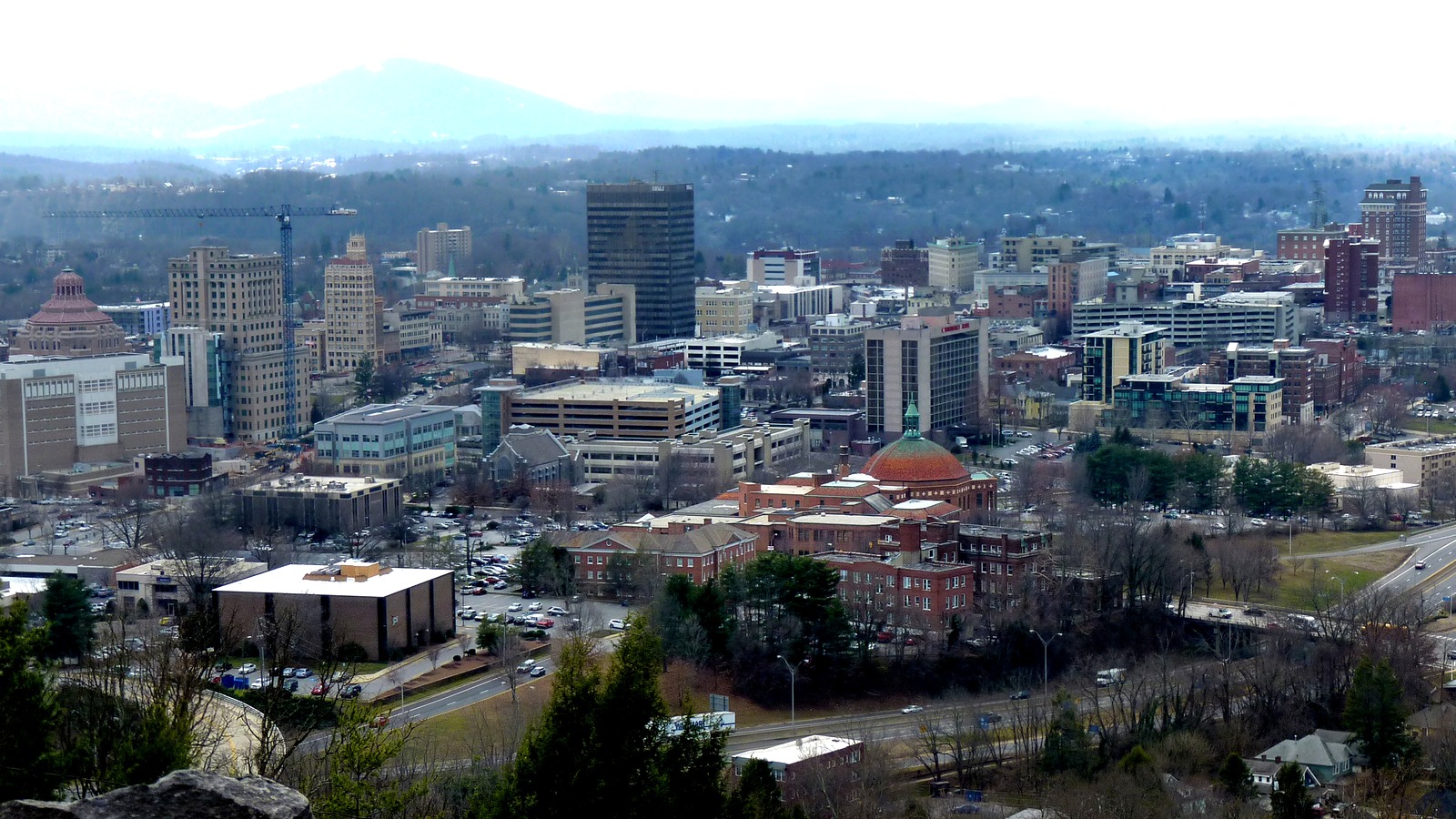 Downtown Asheville with the Blue Ridge mountains beyond the city