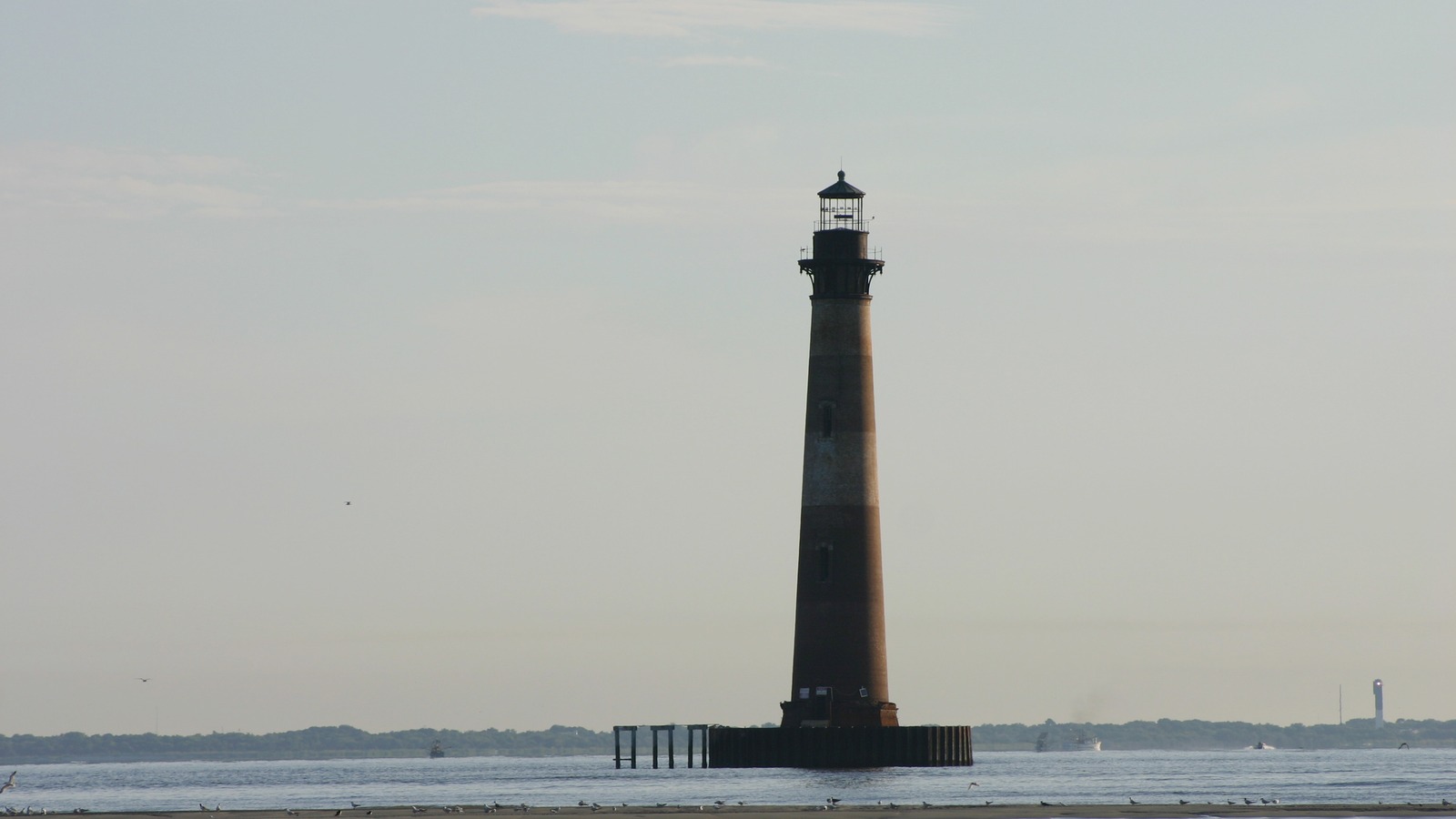The Morris Island Lighthouse standing in the water off the east end of Folly Beach, South Carolina