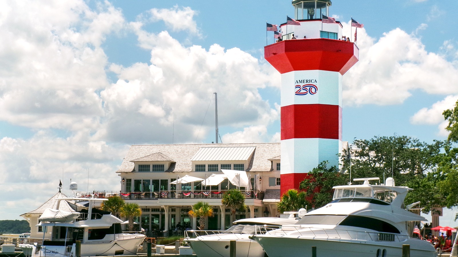 The red and white striped Harbor Town Lighthouse rising above moored boats at the marina in Sea Pines on Hilton Head Island, South Carolina