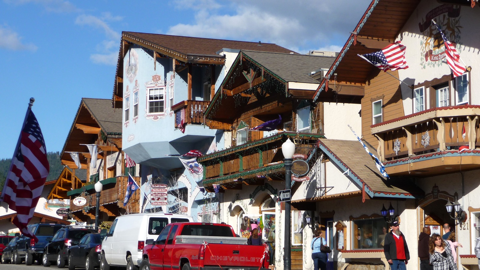 Bavarian style buildings with painted balconies and flags along Front Street in Leavenworth, Washington