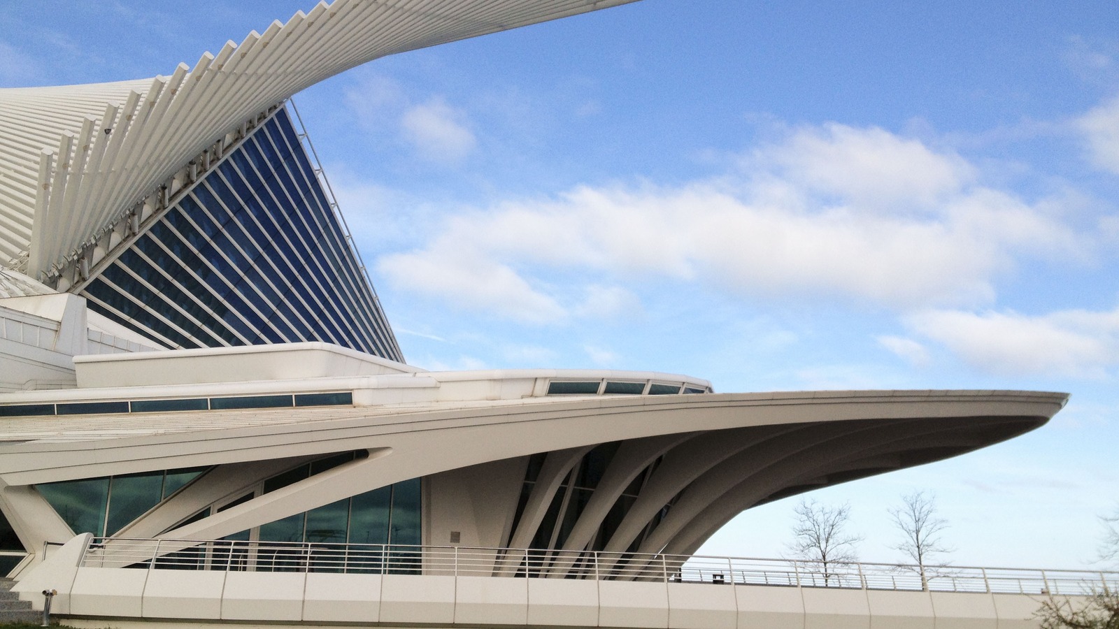 The Quadracci Pavilion of the Milwaukee Art Museum in Milwaukee, Wisconsin, with its white brise soleil wings open against a blue sky