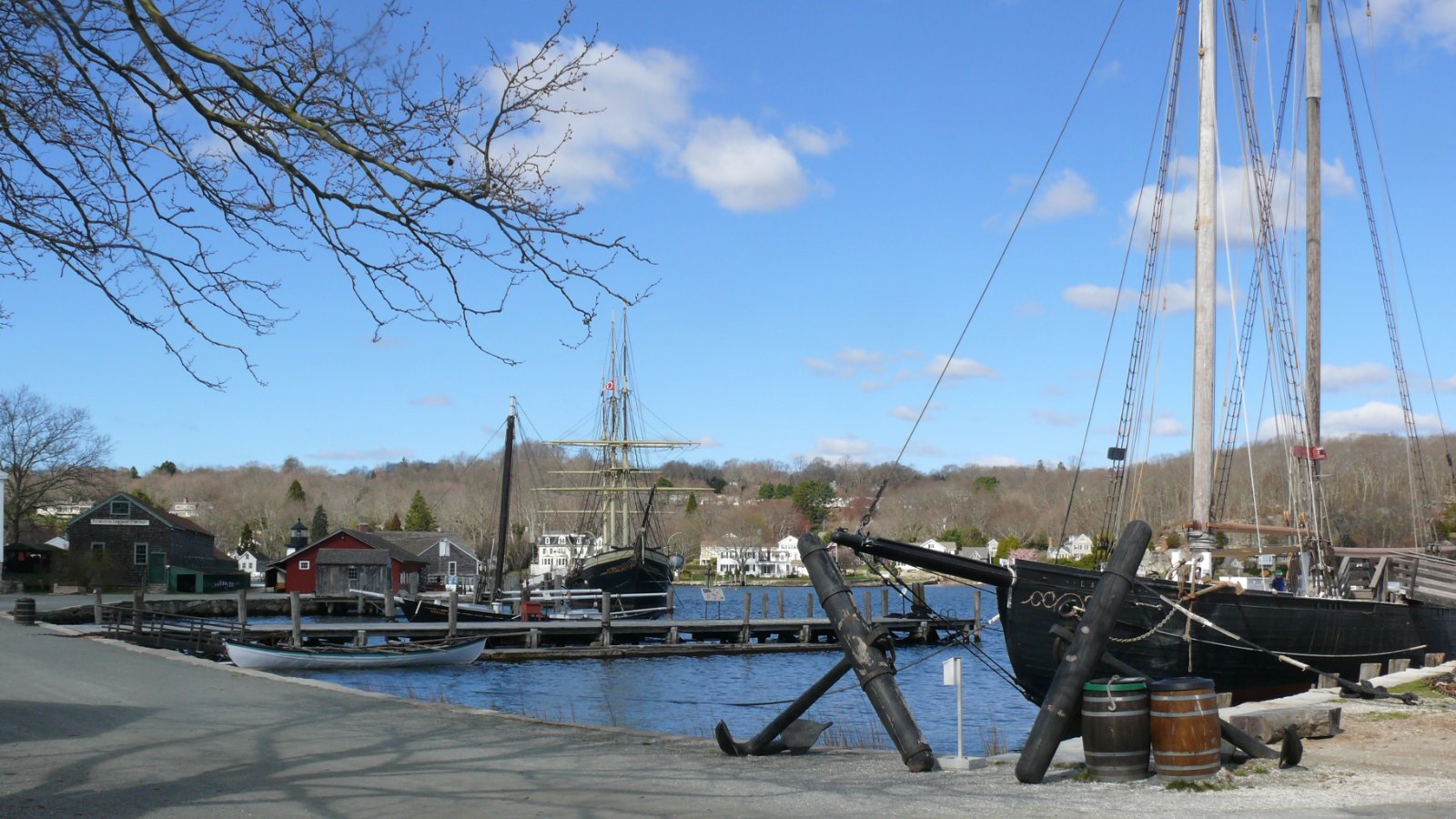 Tall ships moored along the waterfront at Mystic Seaport Museum in Mystic, Connecticut