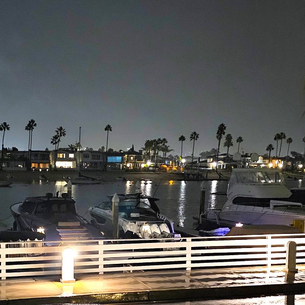 Boats, shops and waterfront walkways at Lido Marina Village in Newport Beach