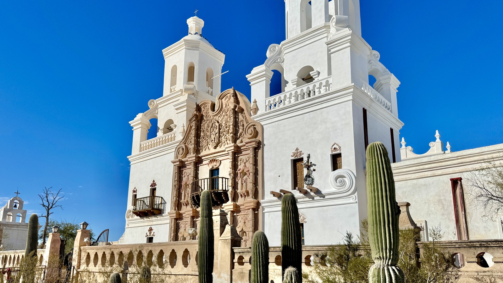 The white domed and towered facade of Mission San Xavier del Bac south of Tucson under a clear sky