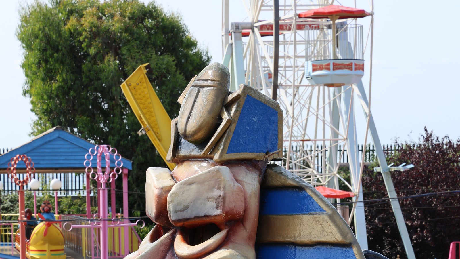 Big Wheel at Adventure Island behind a themed park statue