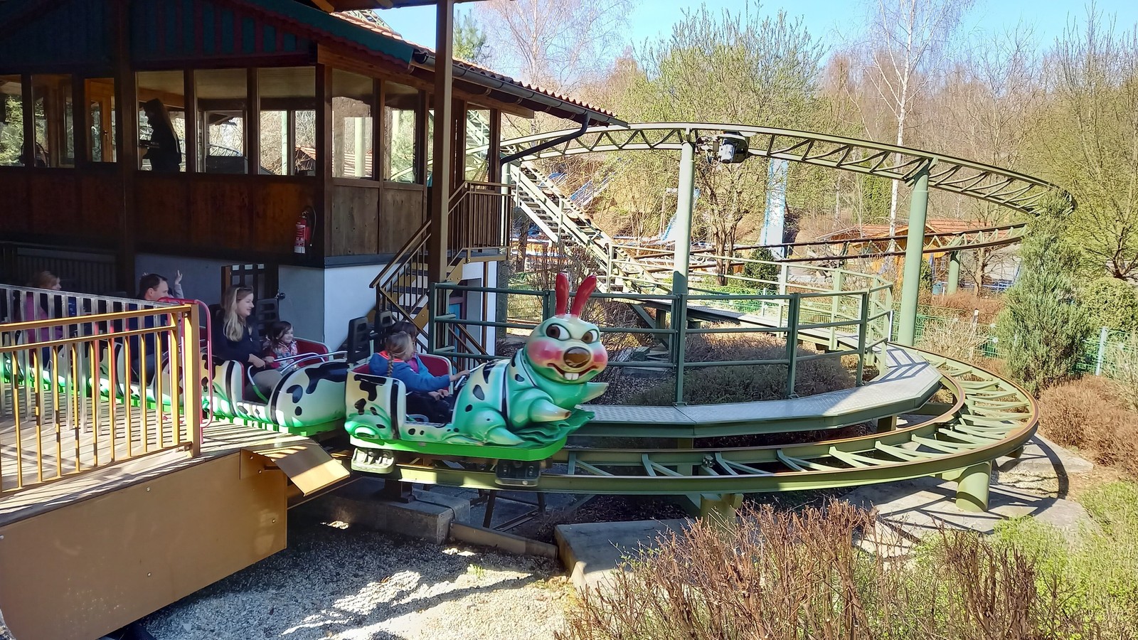 Green caterpillar themed Raupenachterbahn coaster train and track at Bayern-Park
