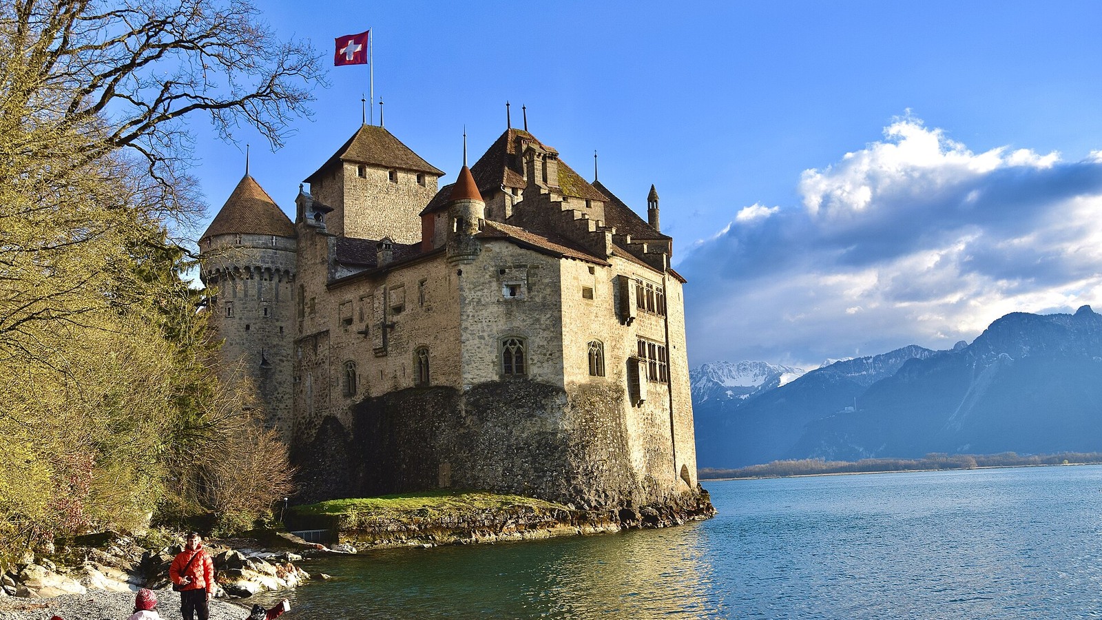 Chillon Castle beside Lake Geneva with mountains beyond