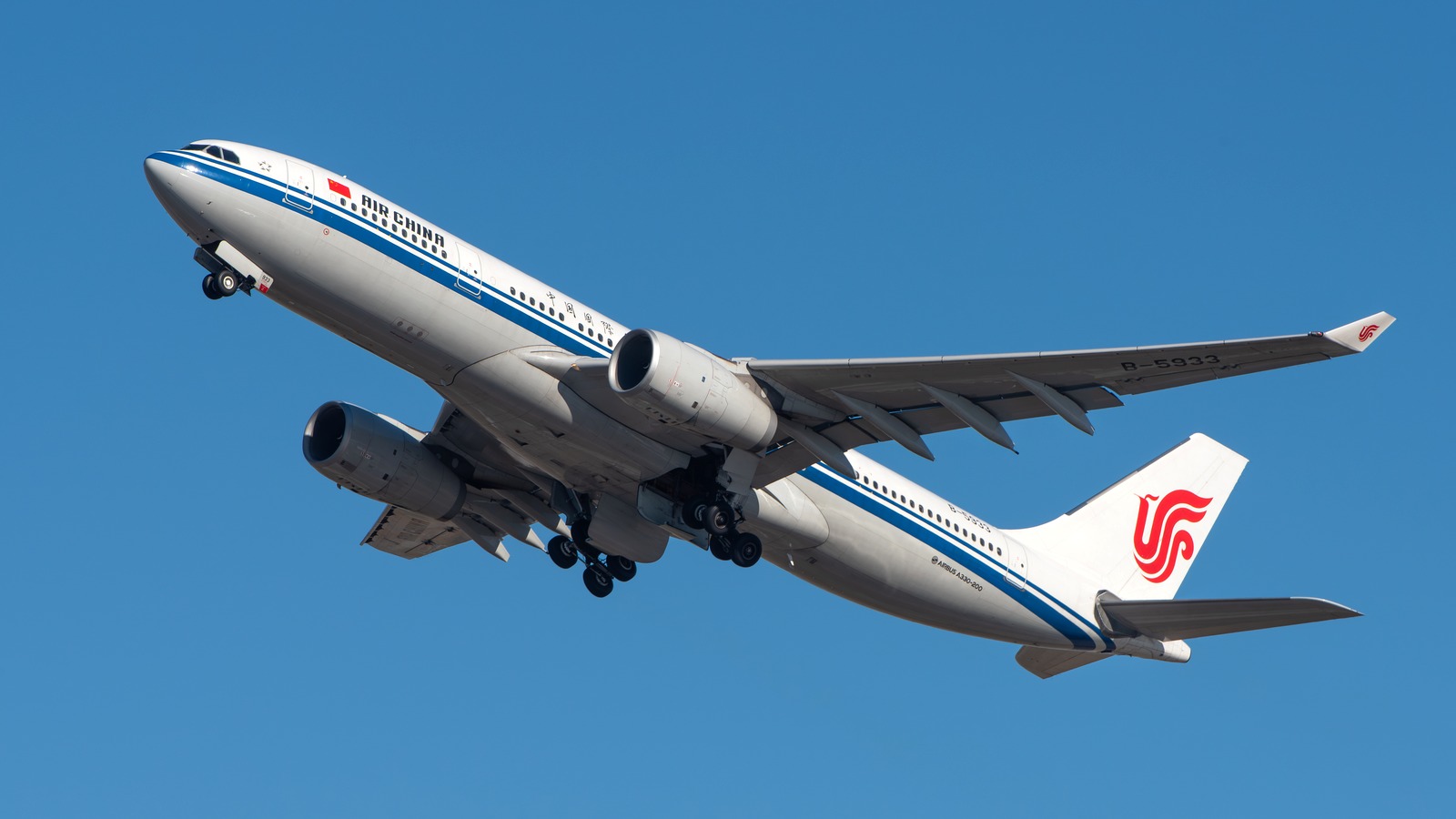Air China Airbus A330-200 in standard livery climbing against a blue sky