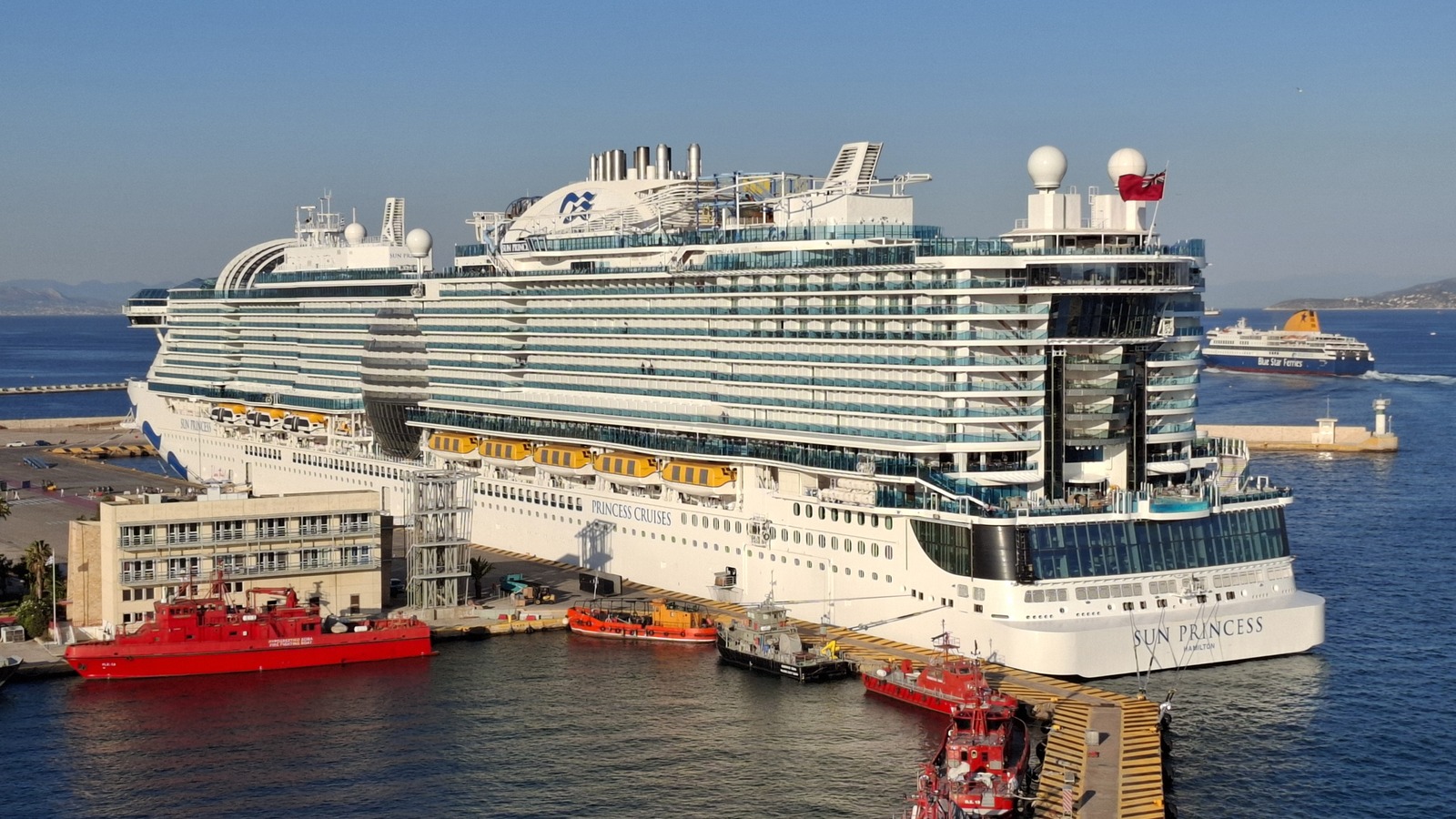 Sun Princess cruise ship docked at Piraeus harbour in daylight, stern view showing Princess Cruises livery
