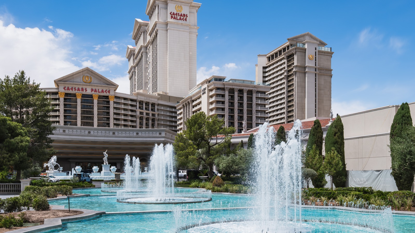 Caesars Palace hotel towers and entrance fountains seen from Las Vegas Boulevard on a clear day