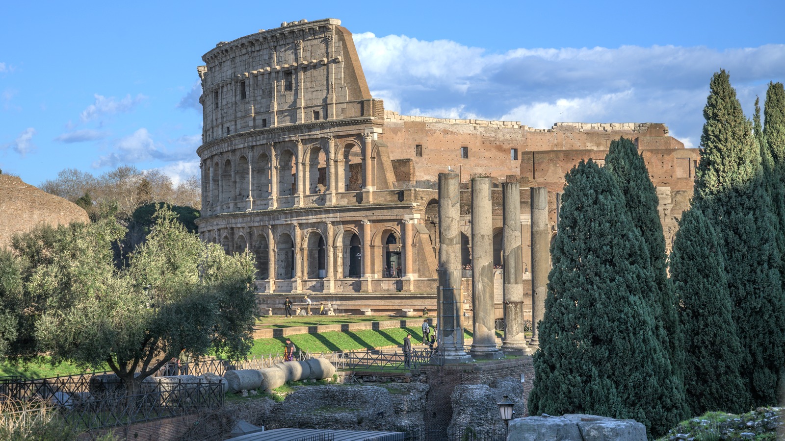 The Colosseum and Roman Forum in Rome under a clear sky