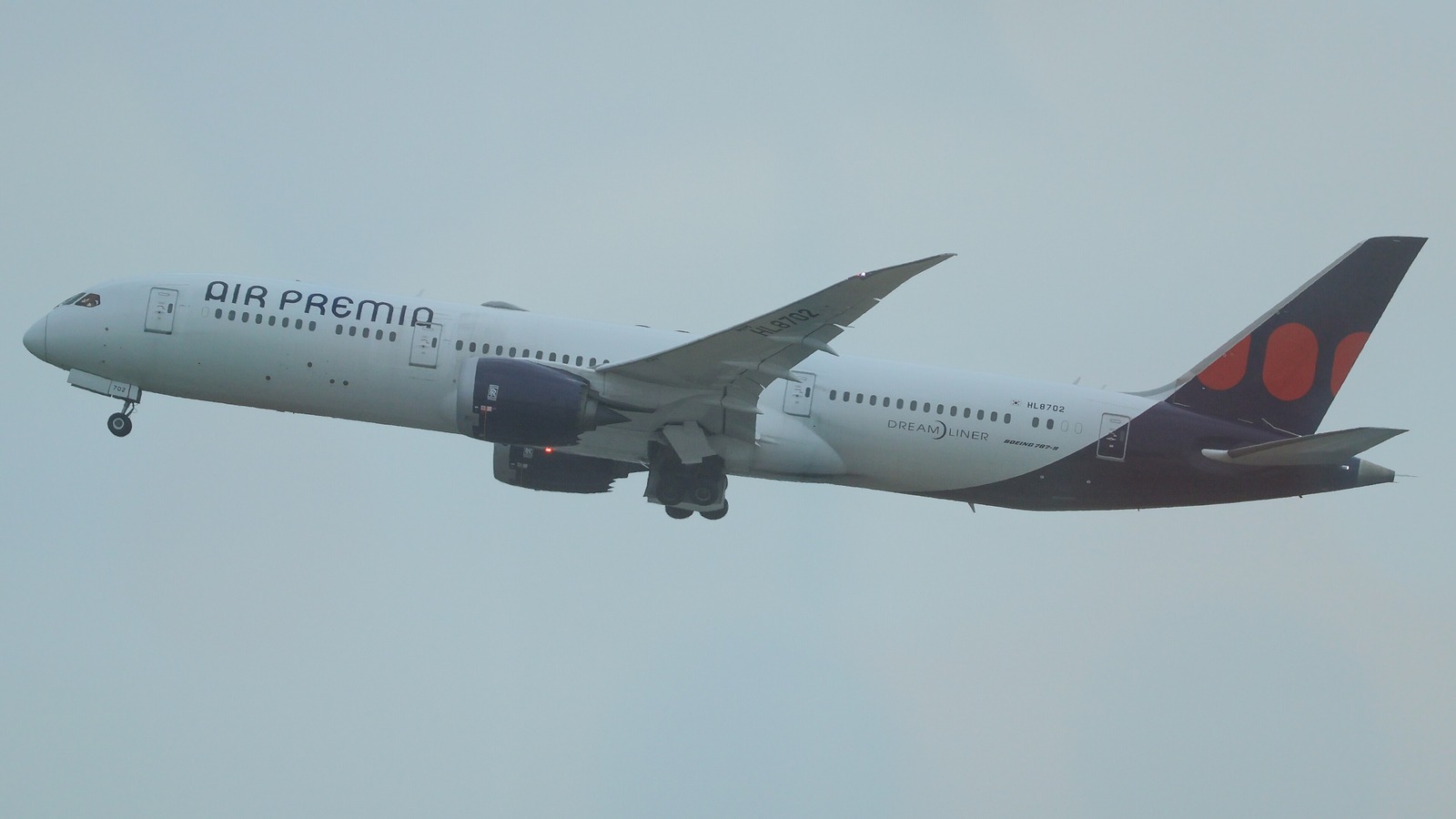 An Air Premia Boeing 787-9 Dreamliner climbing after departure from Seoul Incheon with the Air Premia titles along the fuselage.