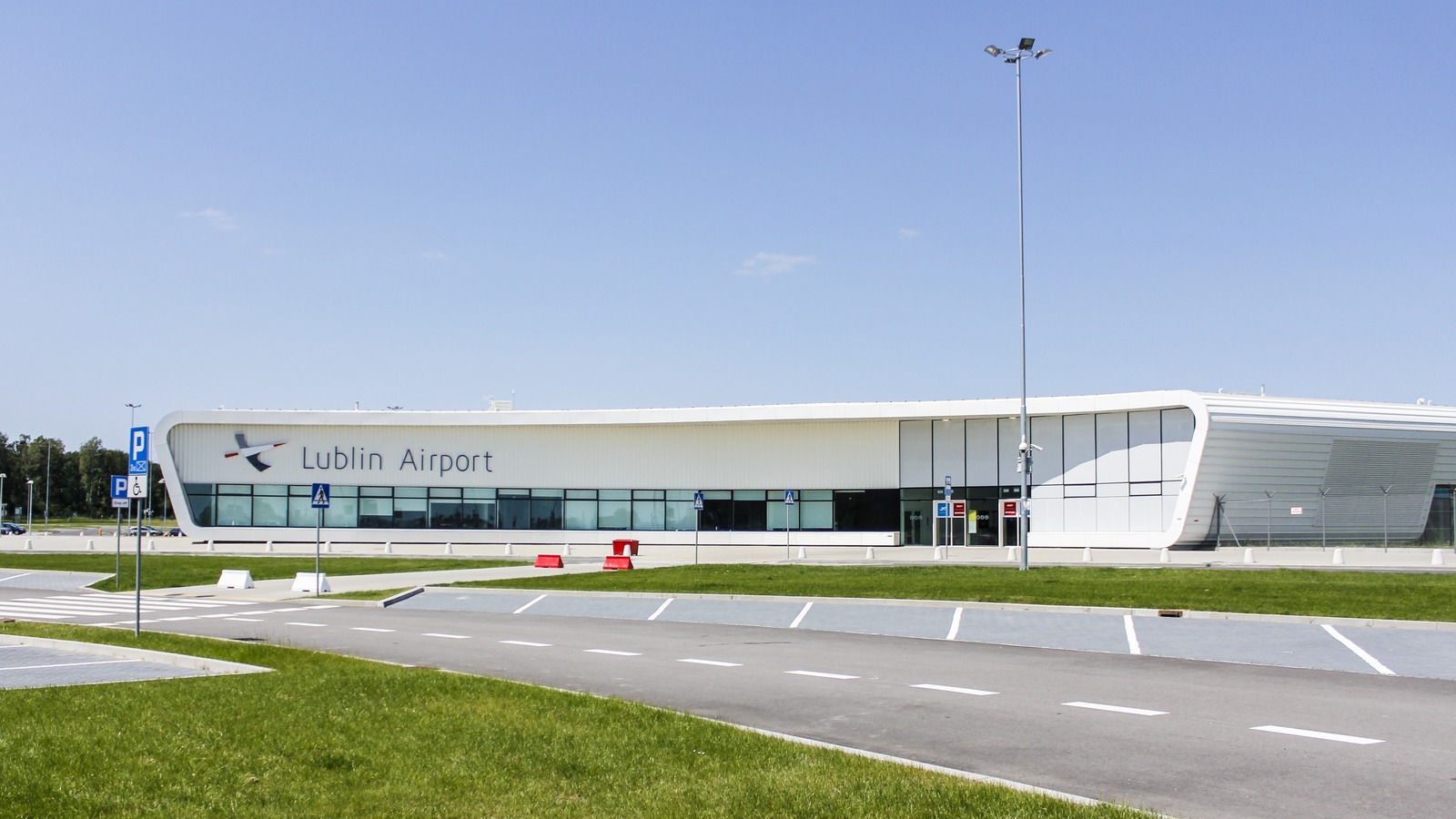 Exterior of the Lublin Airport terminal building with the airport name on the facade