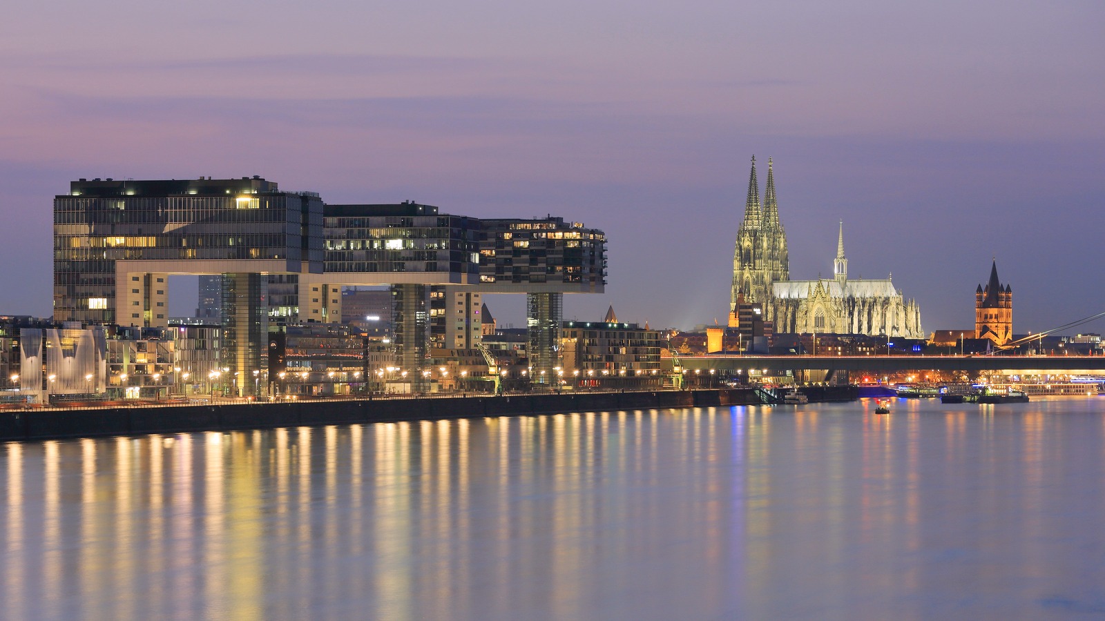 Cologne Cathedral and the Kranhaus buildings on the Rhine at dusk, an included walking-tour call on Crucemundo's Amsterdam to Belgrade itinerary