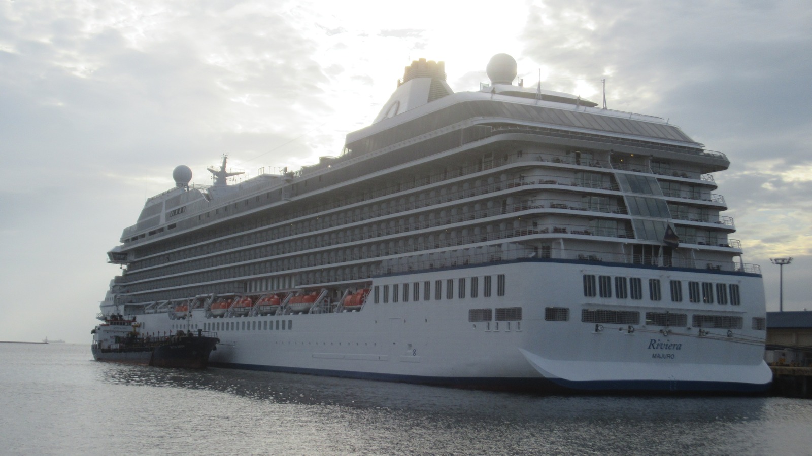 Oceania Cruises ship Riviera docked at Manila Bay, with the name Riviera visible on the bow.
