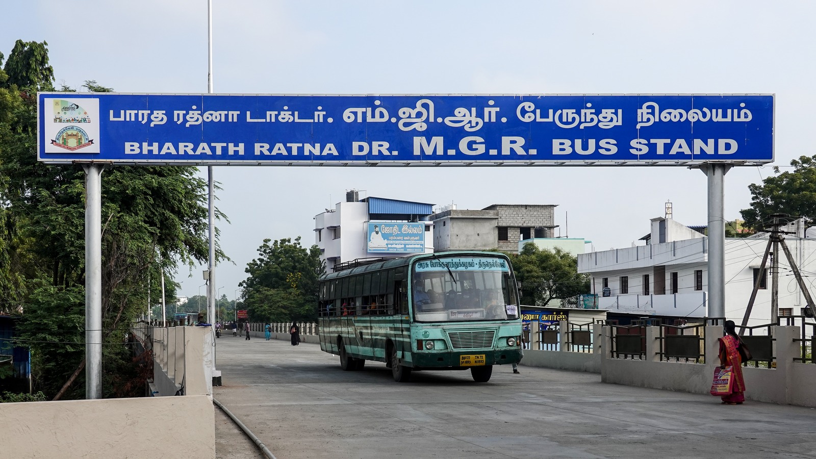 Entrance to MGR Bus Stand from the highway in Tirunelveli, Tamil Nadu, with a coach departing