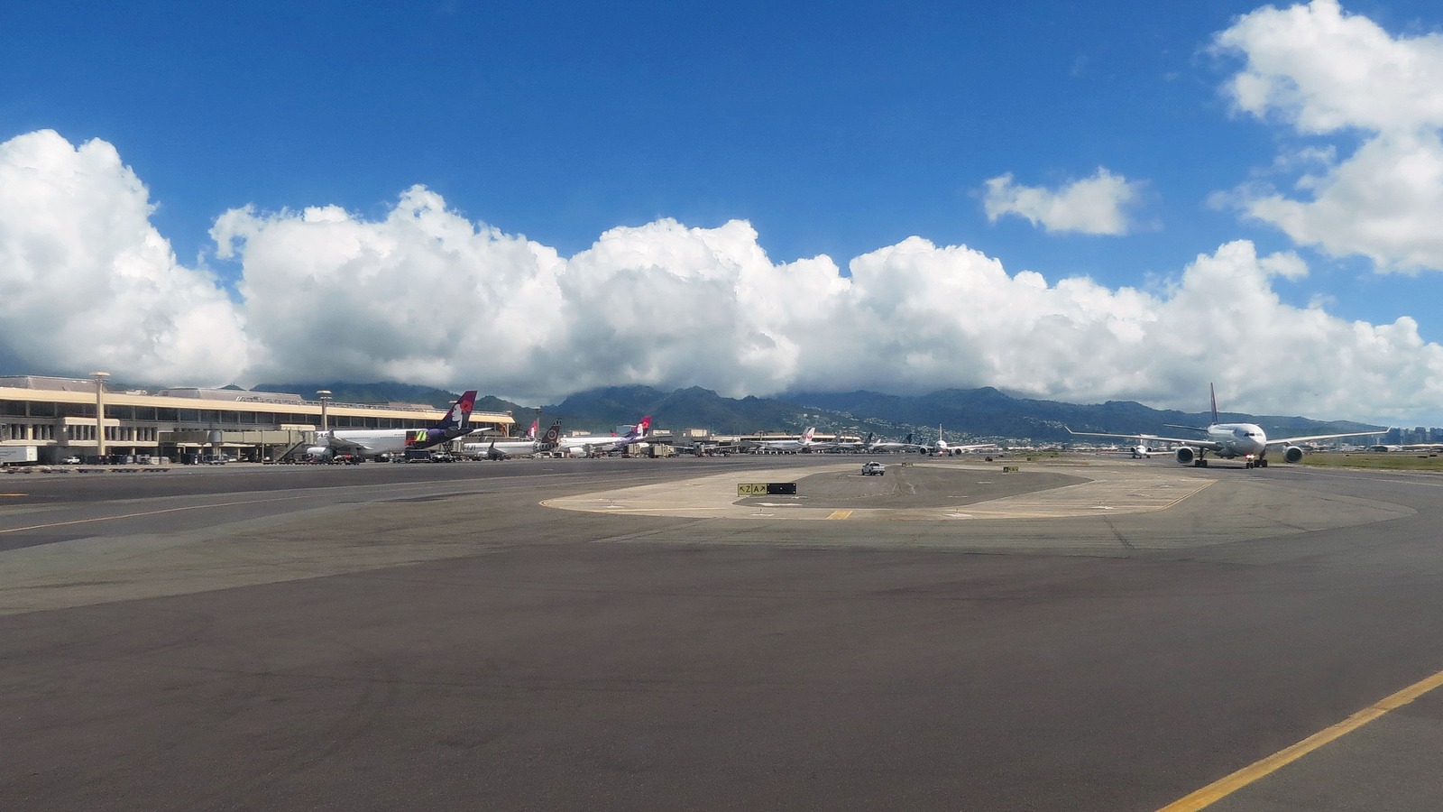 Exterior of Honolulu International Airport on Oahu with terminal buildings and parked aircraft