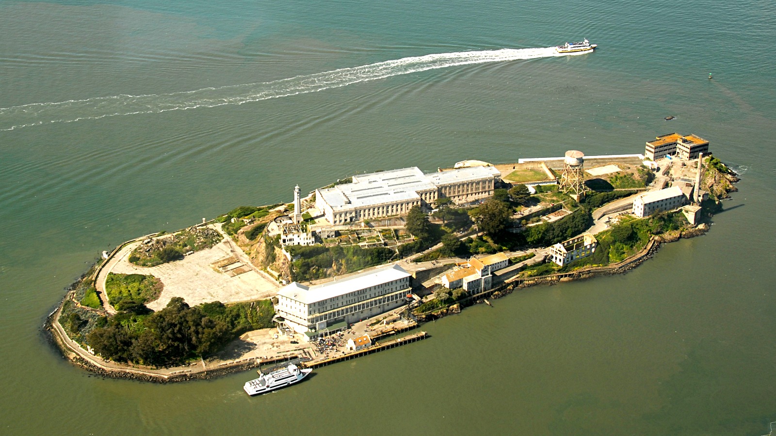 Aerial view of Alcatraz Island in San Francisco Bay with a ferry at the dock