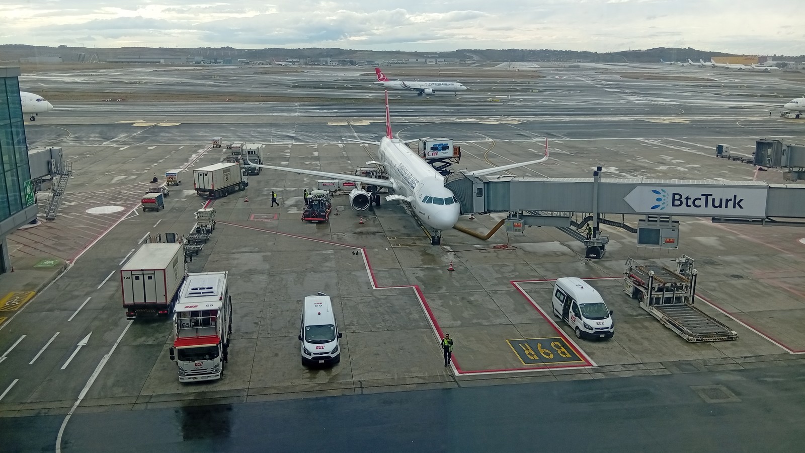 Turkish Airlines passenger jet parked at a boarding gate on the tarmac at Istanbul Airport