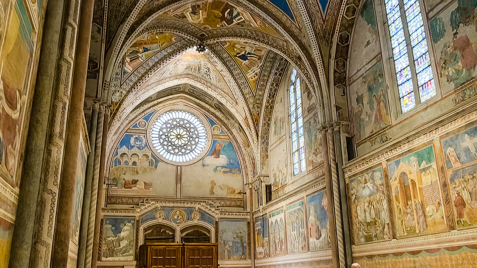 Frescoed interior and rose window of the Basilica of San Francesco in Assisi