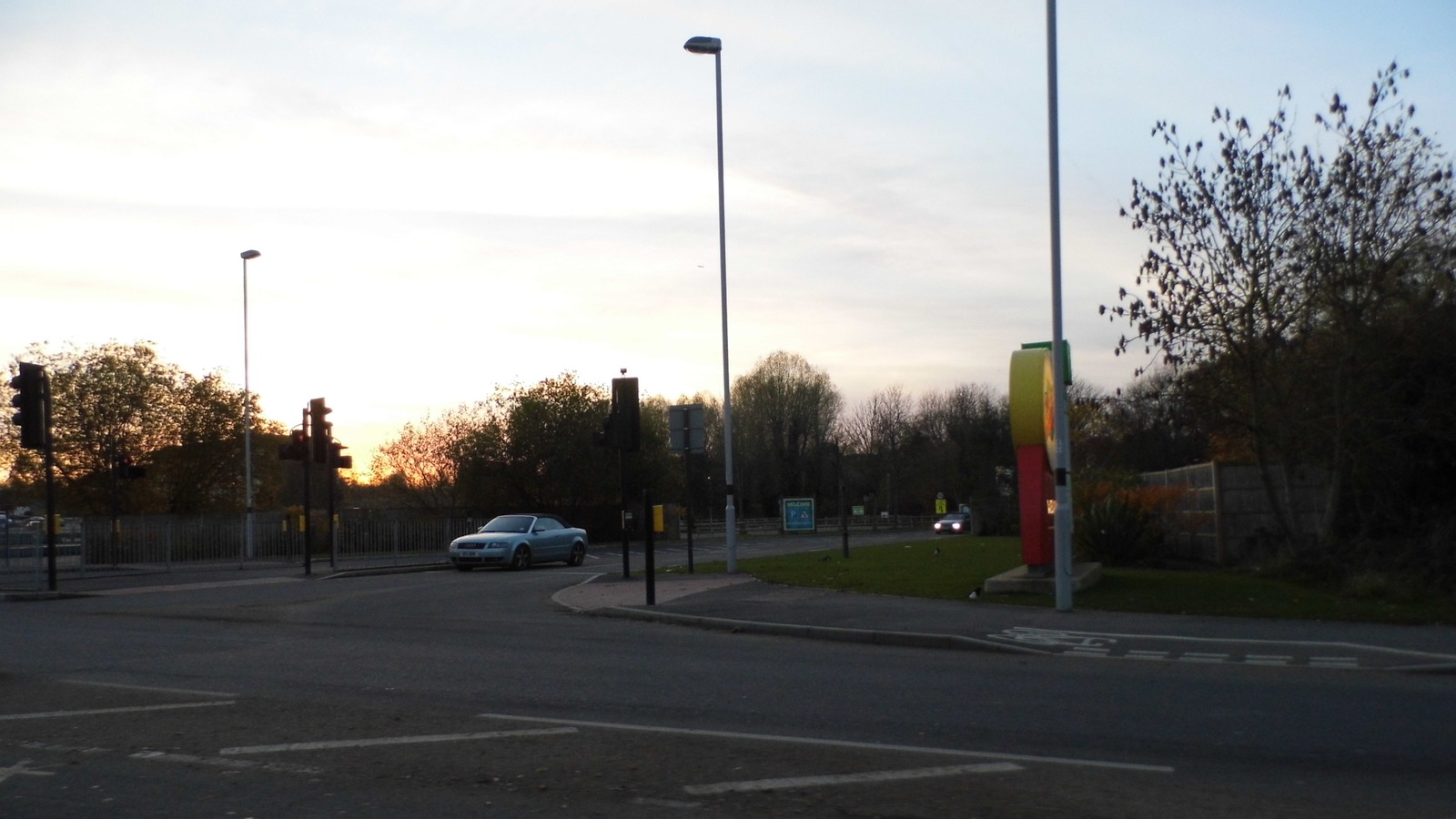 Road approach and colorful totem at the entrance to Chessington World of Adventures in Surrey