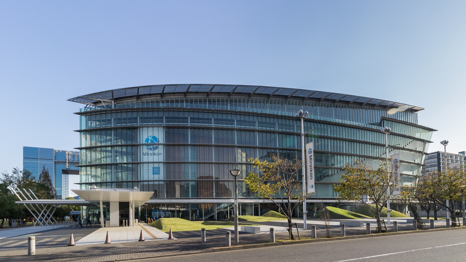 The glass exterior of Miraikan, the National Museum of Emerging Science and Innovation, in Odaiba, Tokyo, under a clear sky in October 2018.