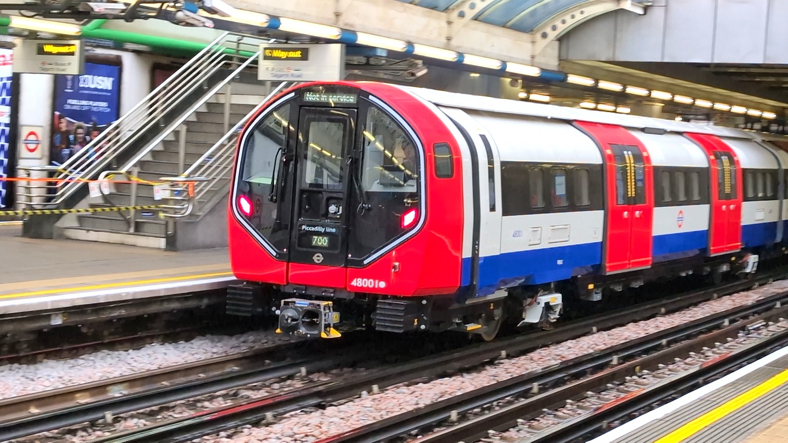 A new red, white and blue Piccadilly line train marked Not in service during testing at Hammersmith station in London.