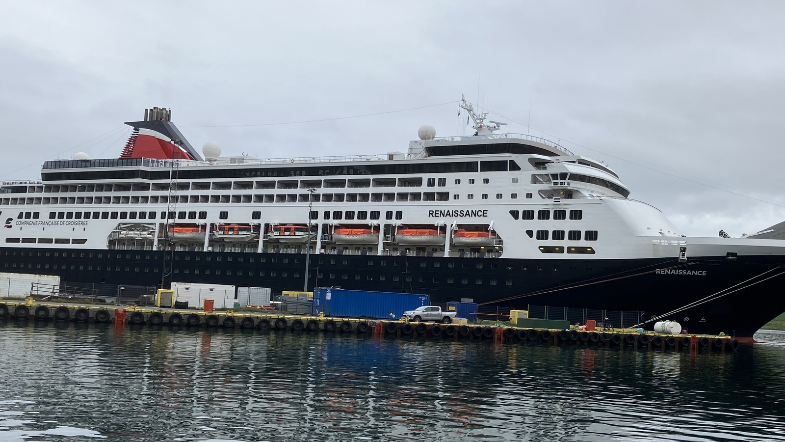 The cruise ship Renaissance moored at Eskifjordur in Iceland, with RENAISSANCE on the hull and bow and the Compagnie Francaise de Croisieres wordmark on the side under an overcast sky