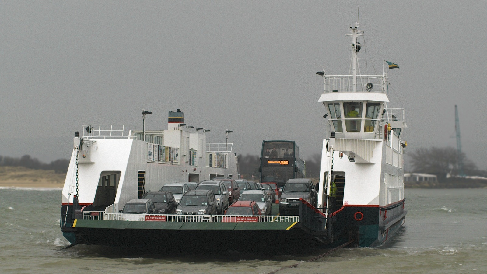 Sandbanks chain ferry carrying cars and a Bournemouth bus across the mouth of Poole Harbour