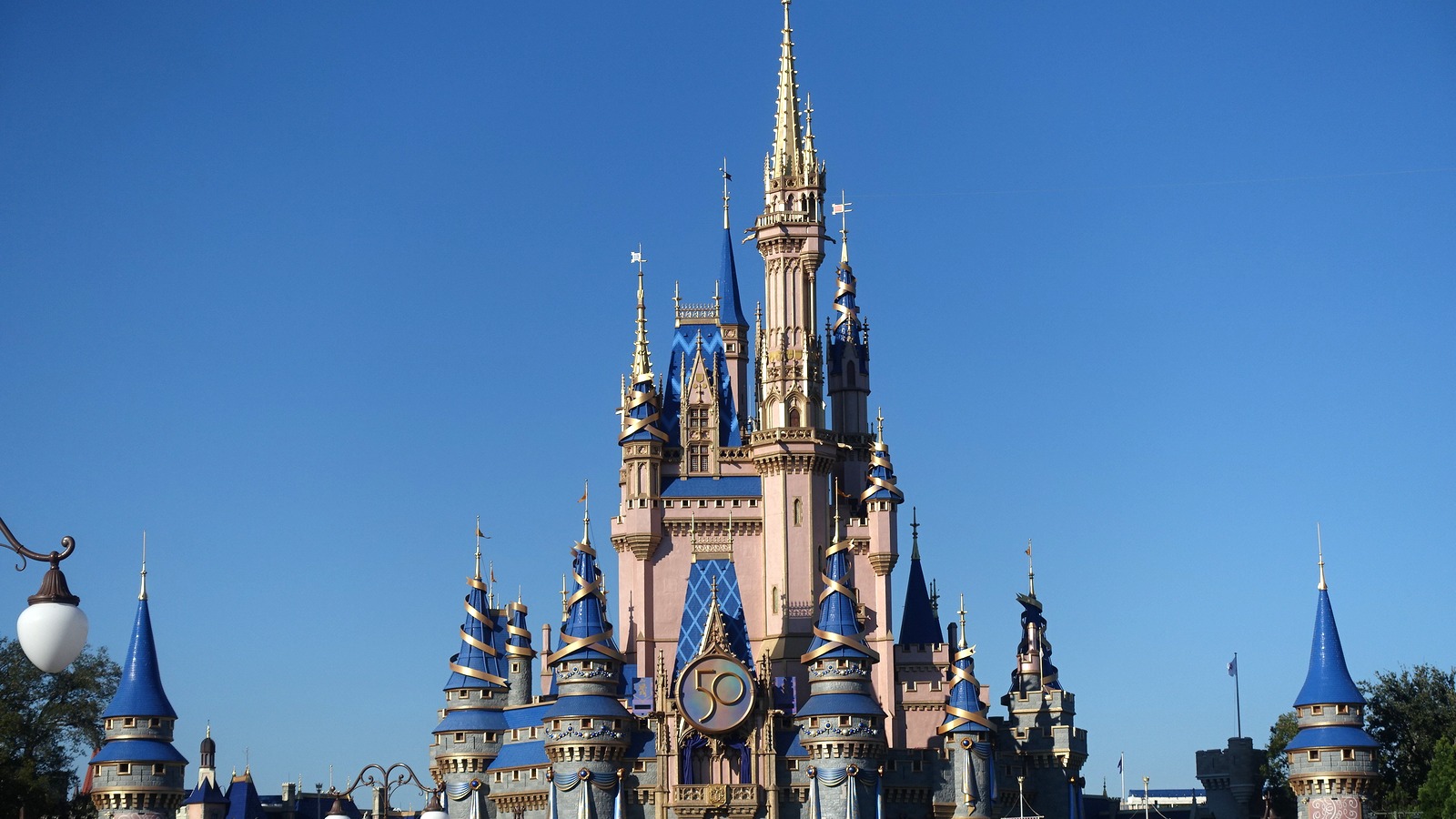 Cinderella Castle at Magic Kingdom photographed in daylight against a clear blue sky
