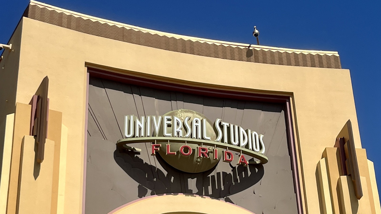 Entrance sign at Universal Studios Florida under a blue sky