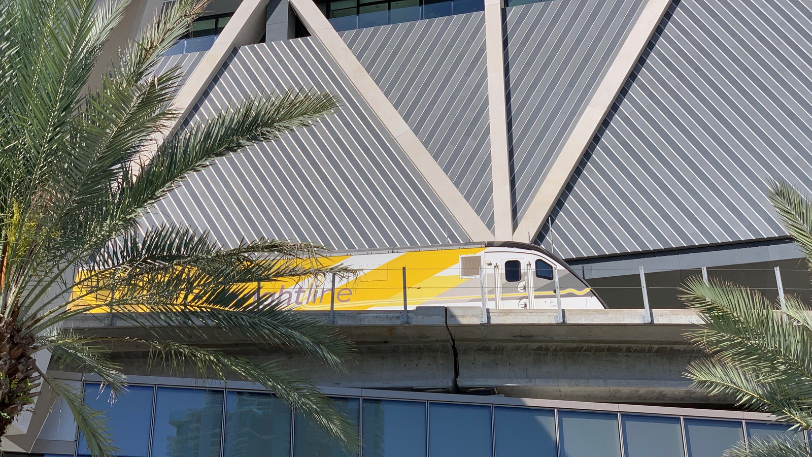 Brightline train beside the MiamiCentral station facade in March 2019, an archival view of the operator