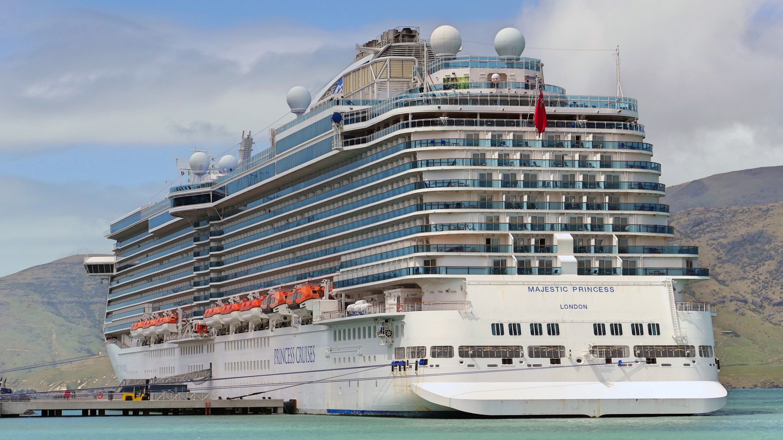 Majestic Princess cruise ship stern and starboard at a pier, with Princess Cruises lettering and London homeport visible