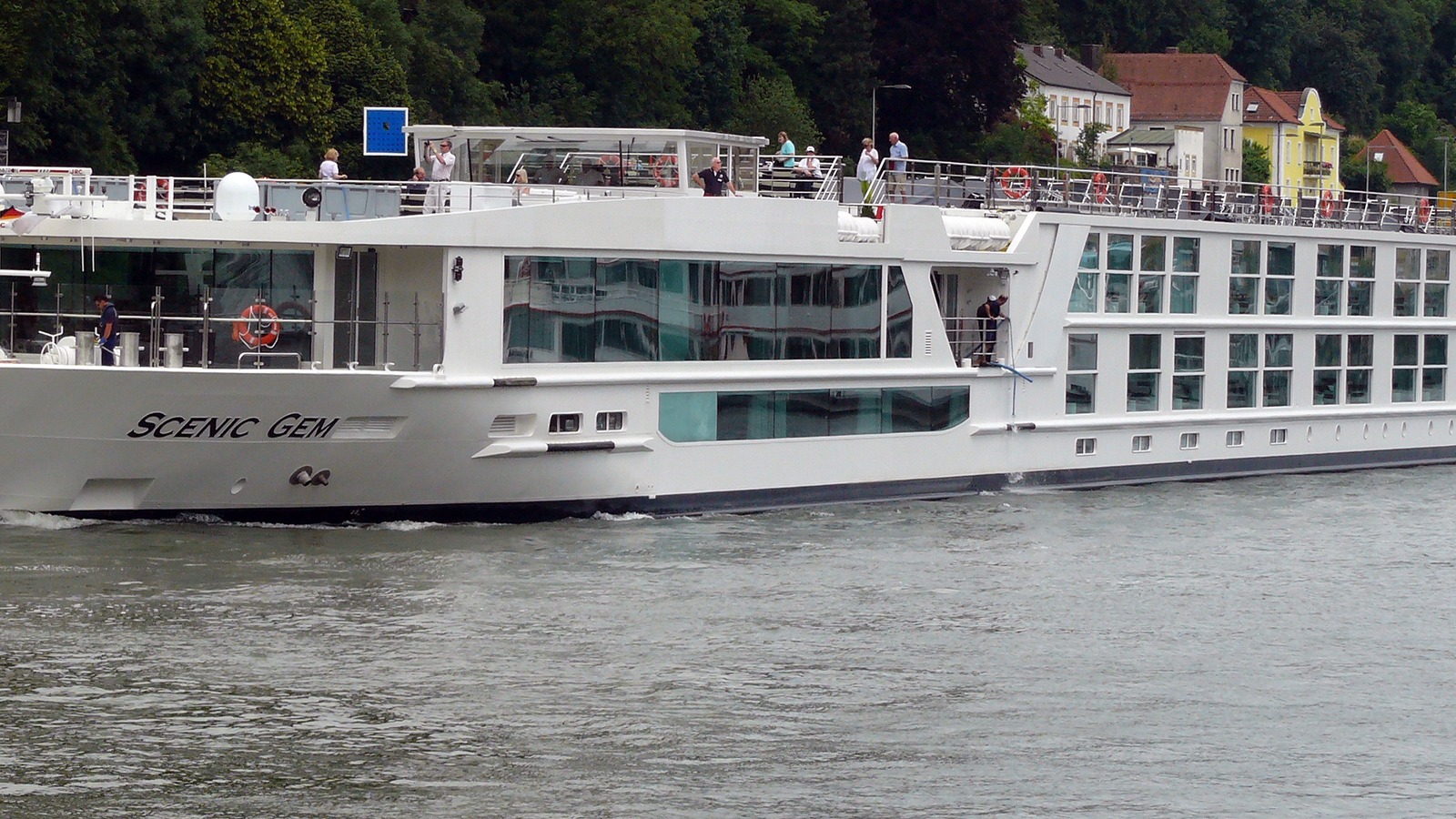 Scenic Gem river cruise ship underway on the Danube at Passau, with the ship name visible on the hull
