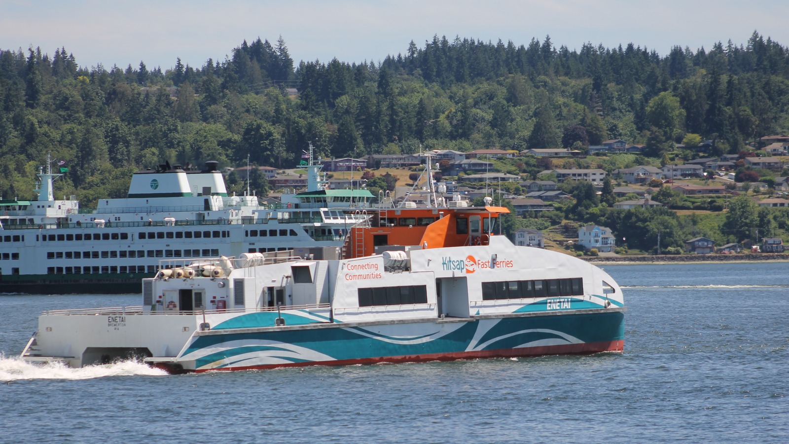 The Kitsap Fast Ferries vessel MV Enetai under way on Puget Sound off Bremerton, with a Washington State Ferries car ferry behind it