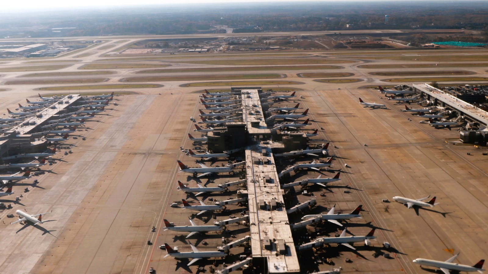 Aerial view of parked jets at gates and runways at Hartsfield-Jackson Atlanta International Airport.