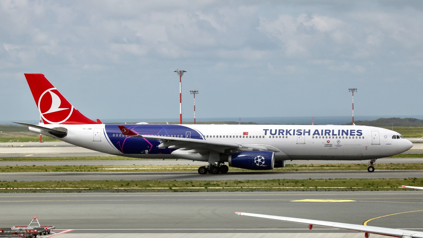 A Turkish Airlines Airbus A330-300 taxiing at Istanbul Airport in a blue special livery, with the Turkish Airlines titles and red tail logo visible.