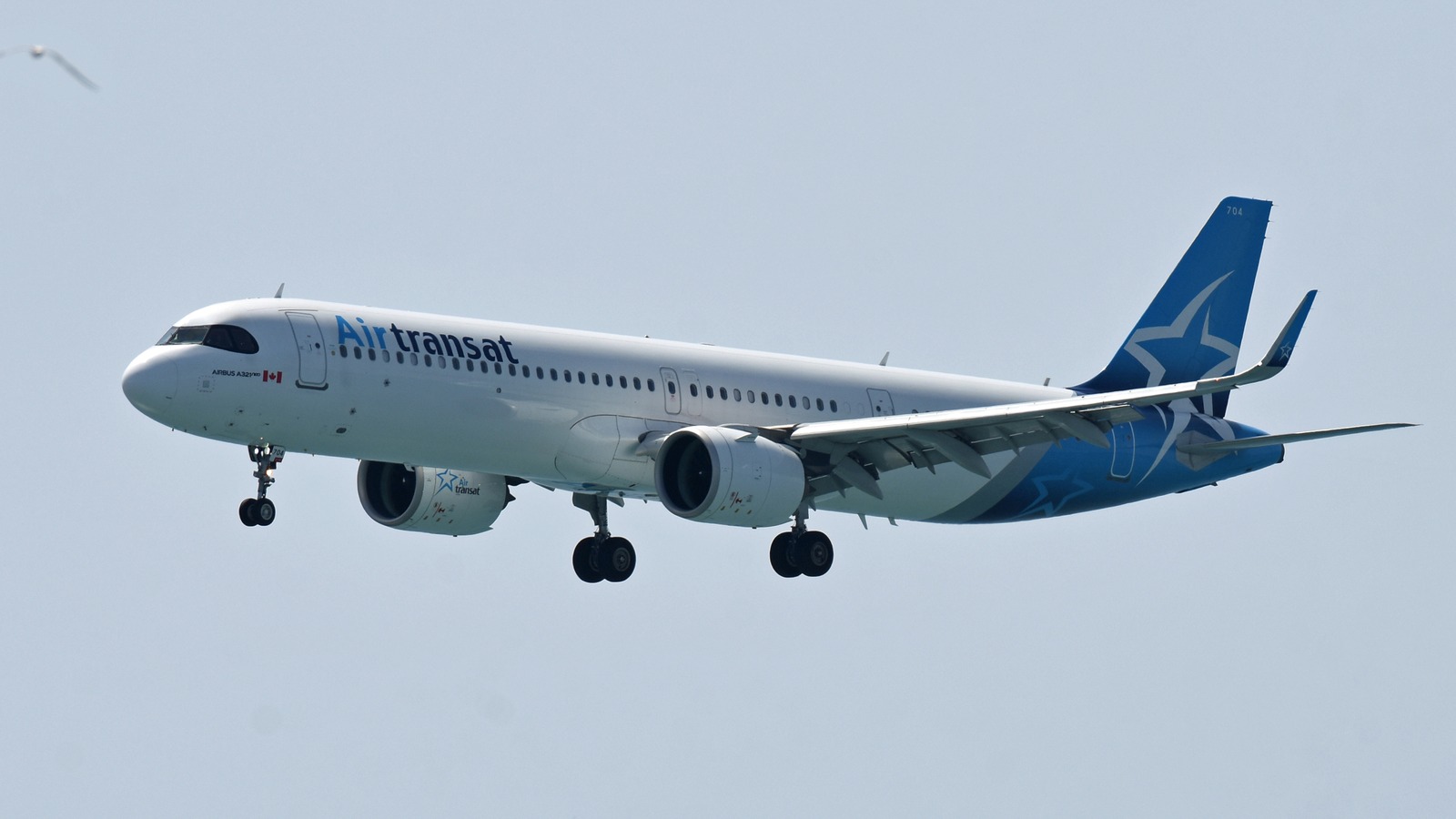 Air Transat Airbus A321neo aircraft in flight showing the current blue star livery